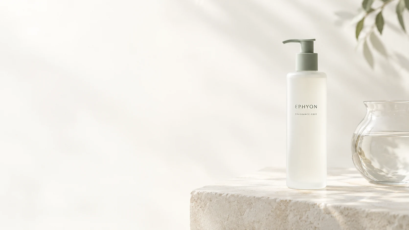 EPHYON ivory pump-bottle packaging concept beside clear water in soft daylight